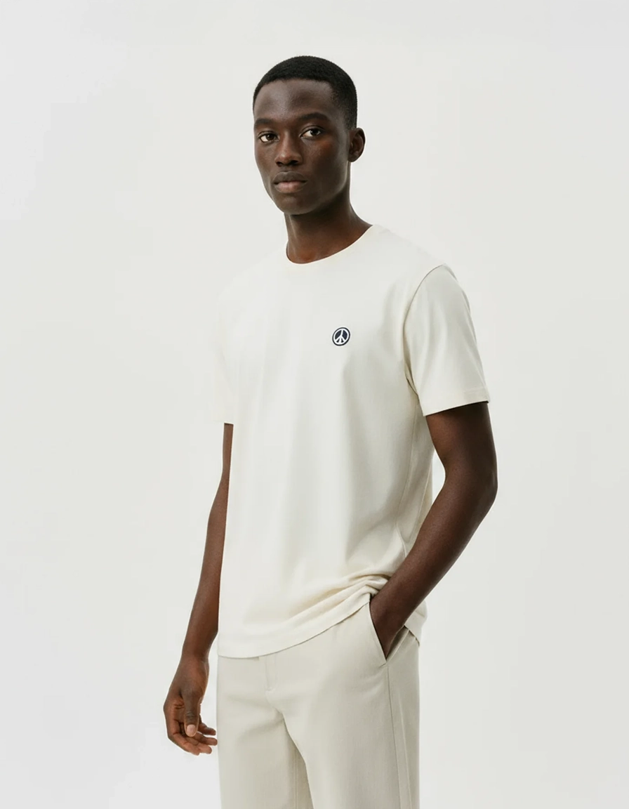 Man wearing a white ponlo.com t-shirt with a small logo on a plain background