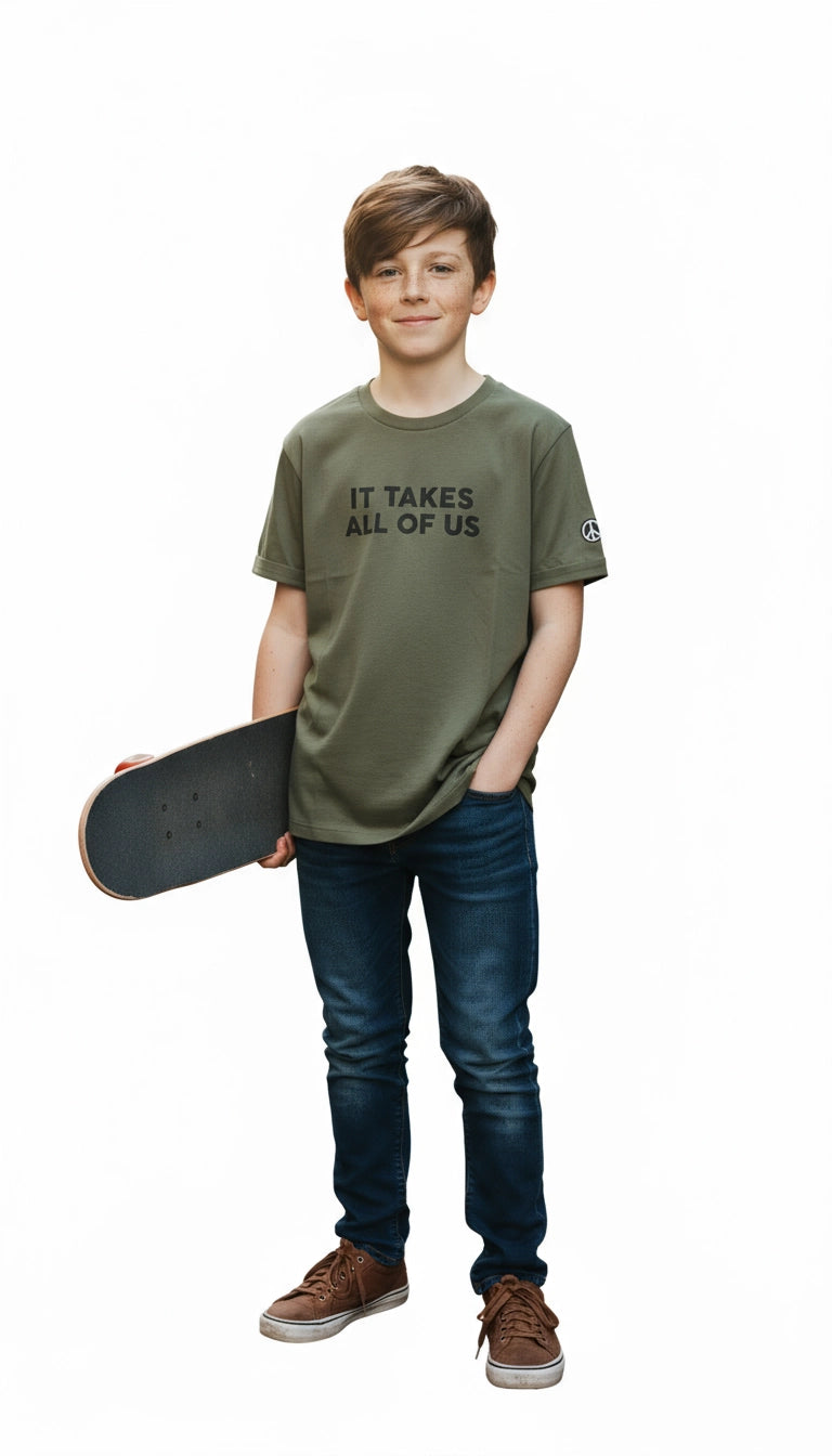 Young boy holding a skateboard wearing an olive green t-shirt with text
