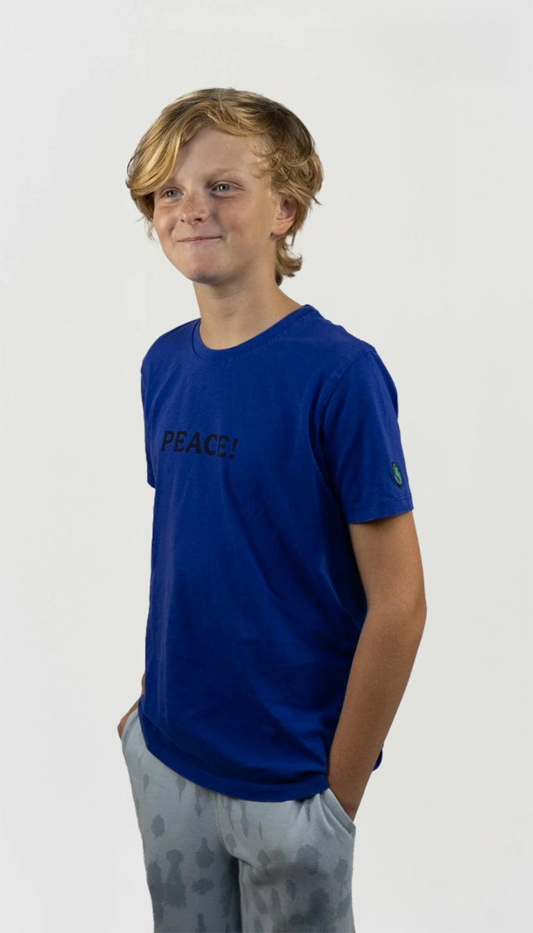 Ten ager wearing an organic cotton blue t-shirt made by ponlo.com with the word 'PEACE!' on a white background